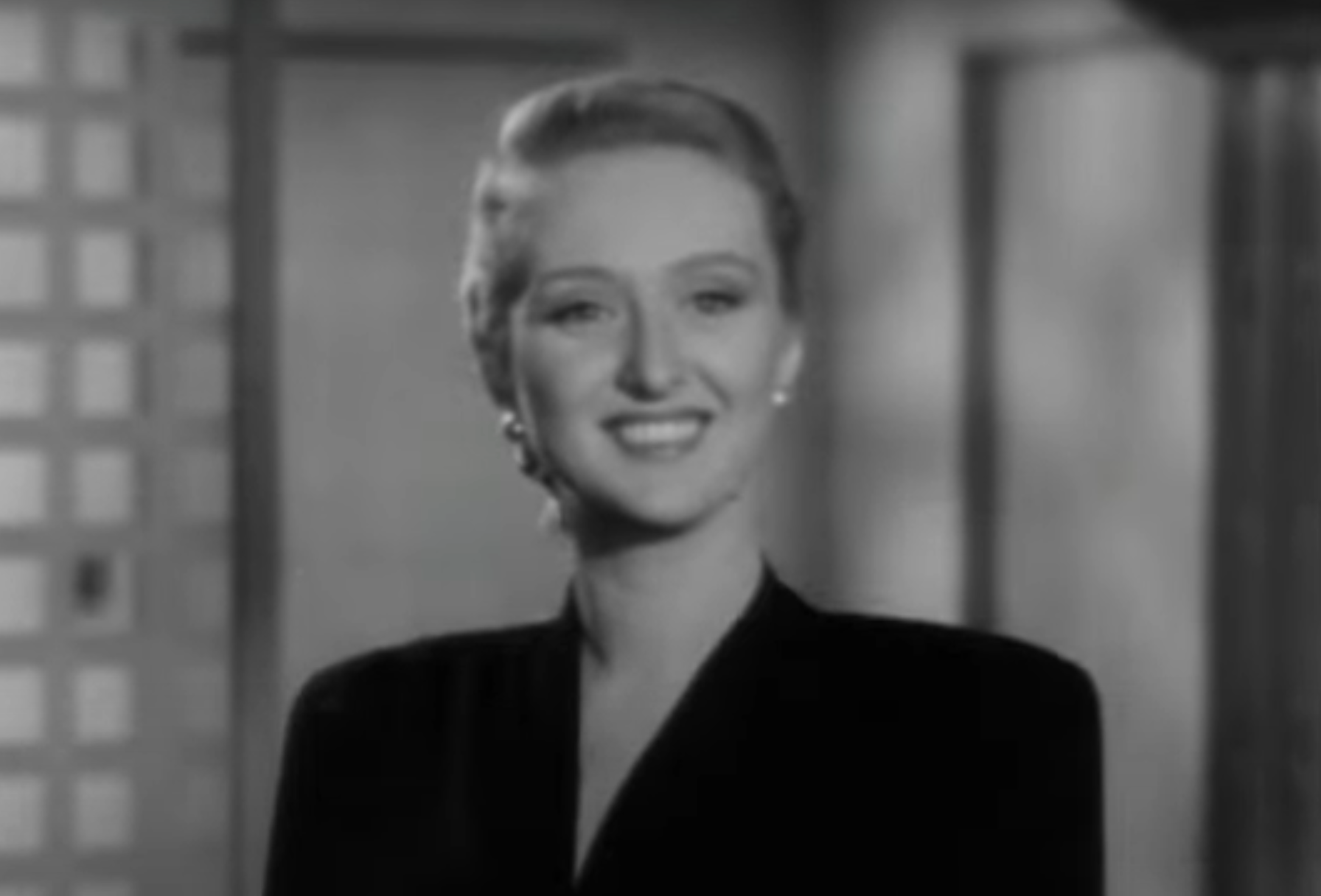 Vintage black and white photo of an elegant woman smiling