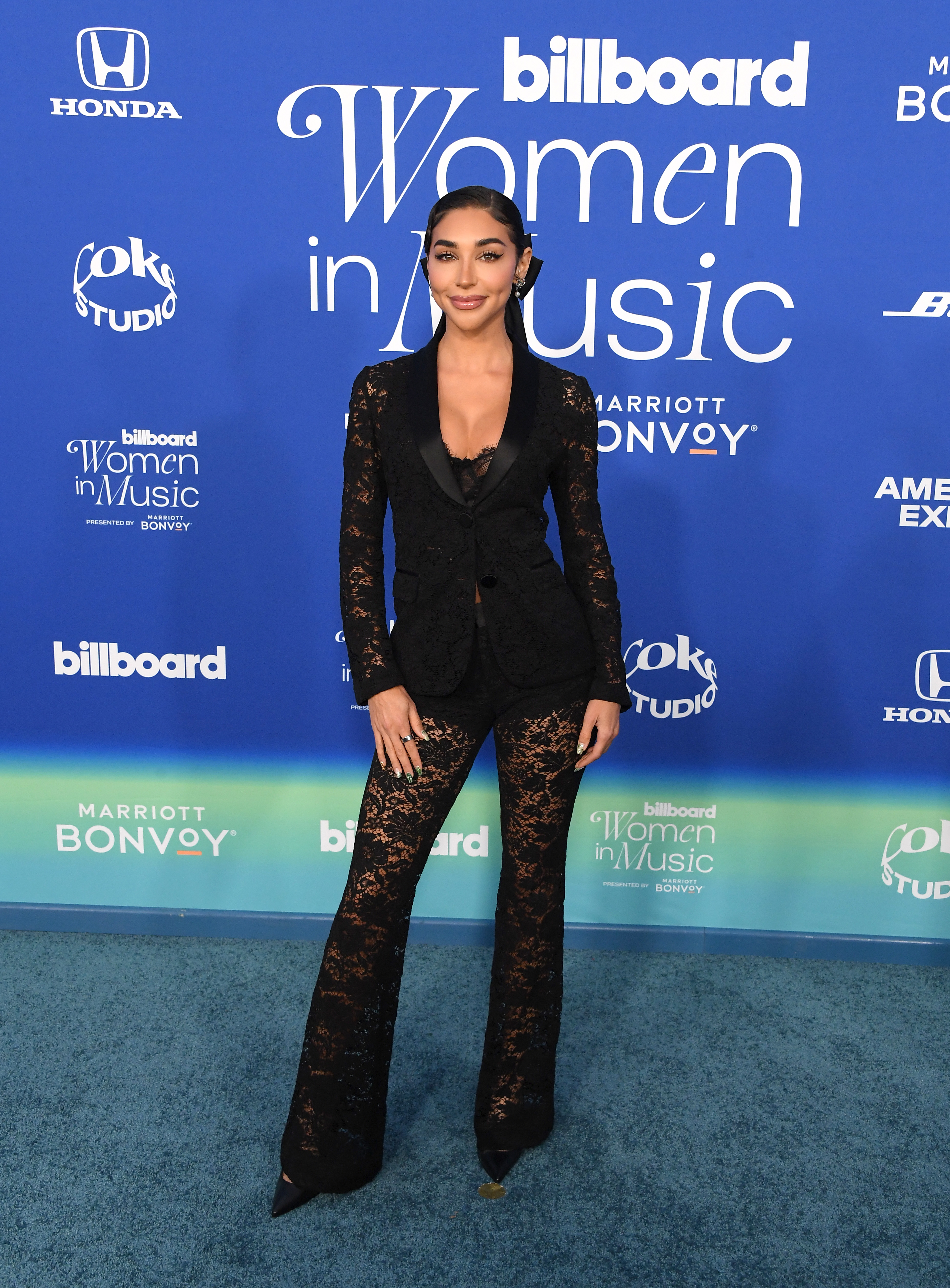 She&#x27;s wearing an embellished black pantsuit with a plunging neckline