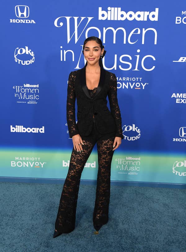 She's wearing an embellished black pantsuit with a plunging neckline
