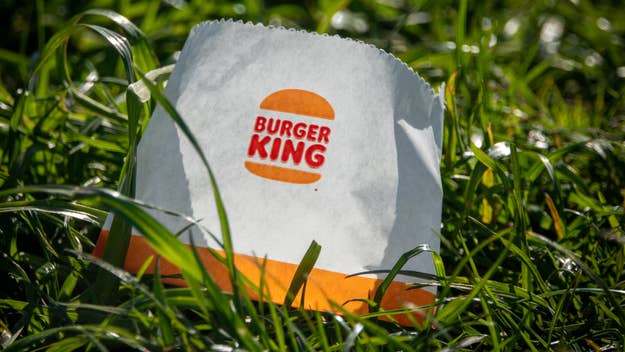 Burger King paper bag discarded on grass, highlighting environmental issue of littering