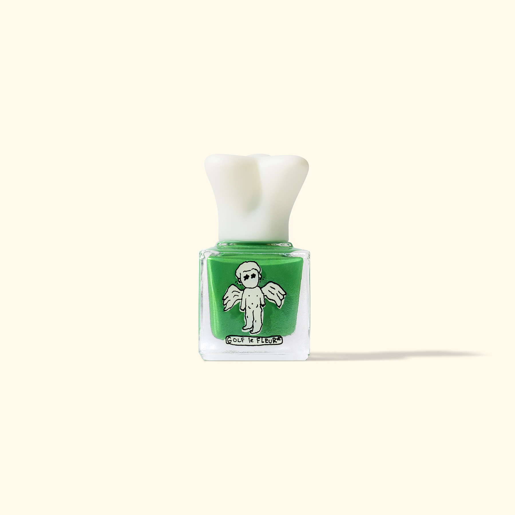 Bottle of green nail polish with a skull design on the label, against a plain background