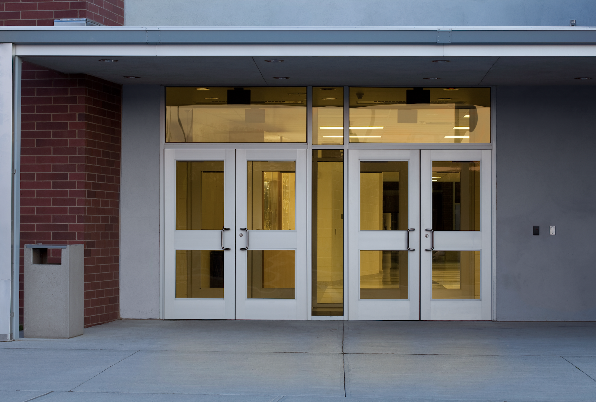 Entrance to a modern building with a set of double glass doors, indicating access to a workplace