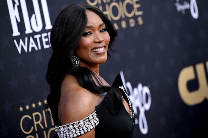 Angela Bassett smiling in an off-shoulder gown with sparkling embellishments at an awards event