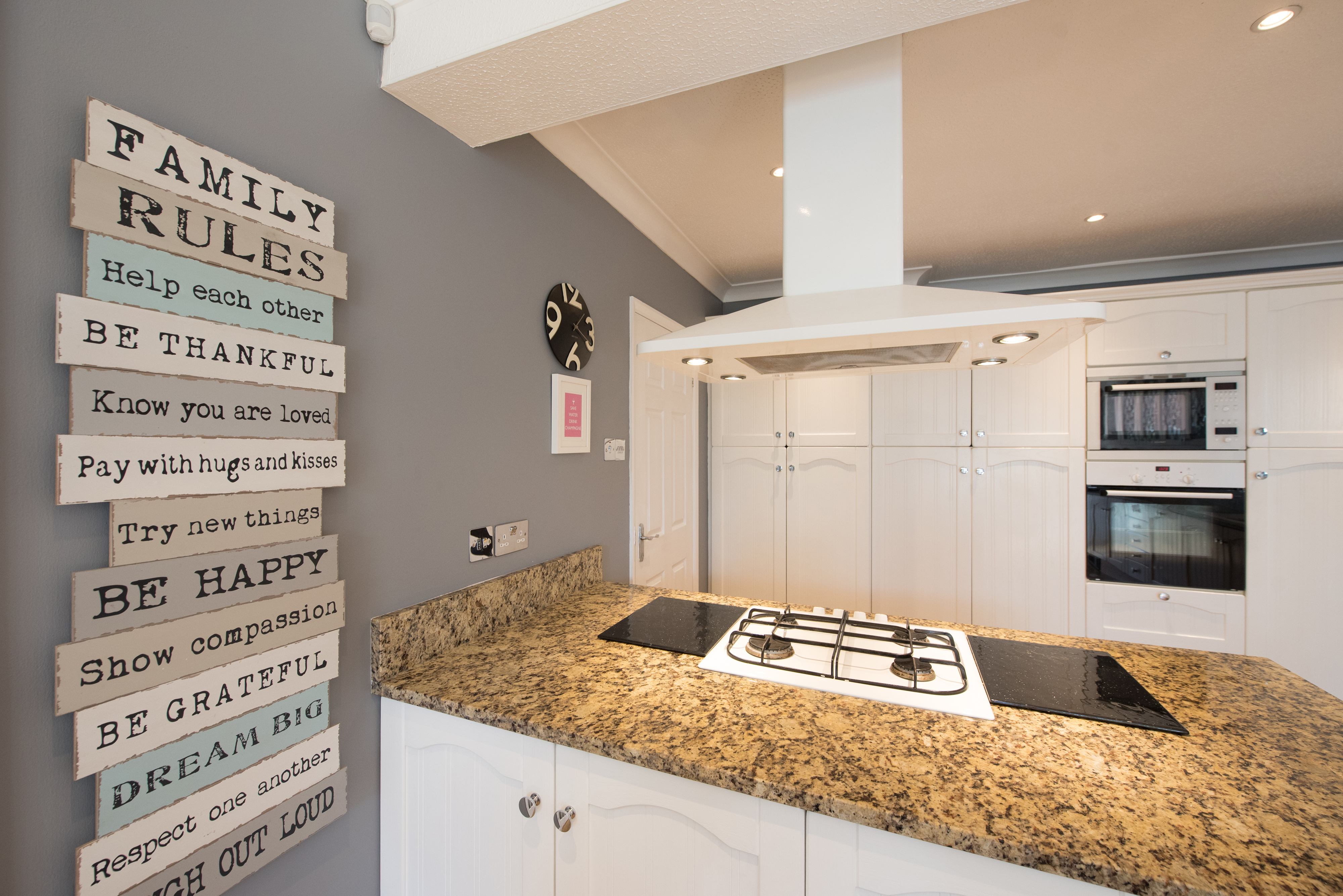 Modern kitchen interior with a list of family rules on the wall