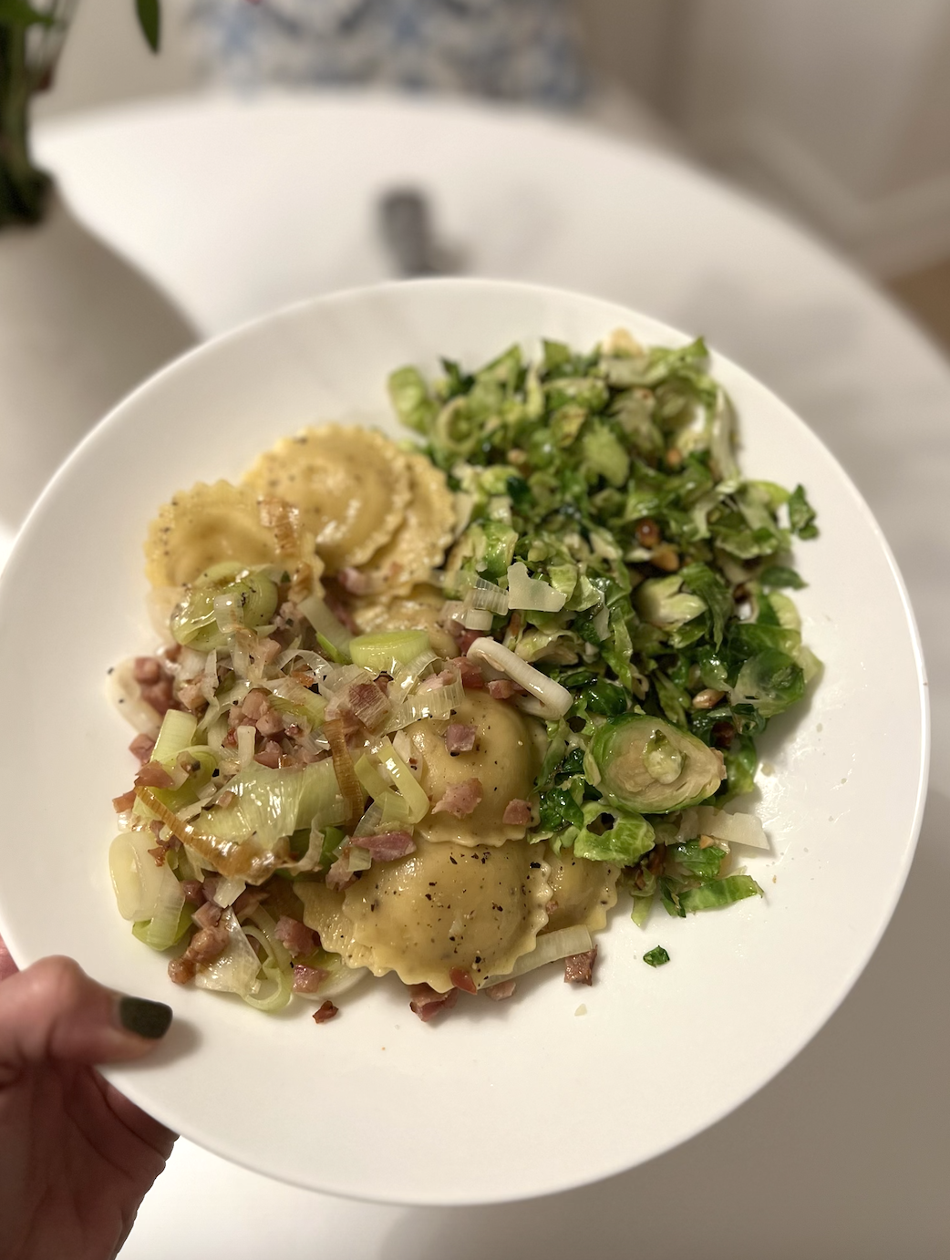 Plate of ravioli with Brussels sprouts and pancetta topping