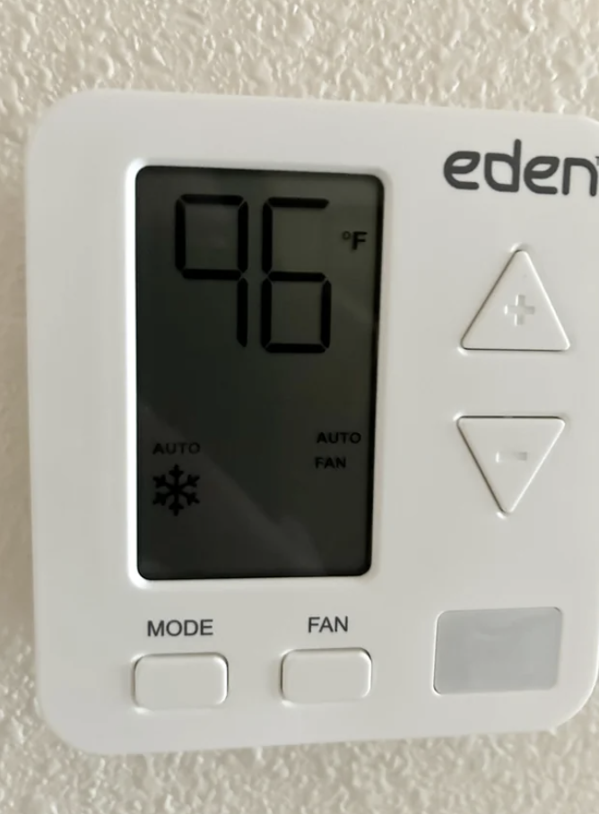 Thermostat displaying high temperature of 96 degrees Fahrenheit, indicating a possible malfunction or heatwave