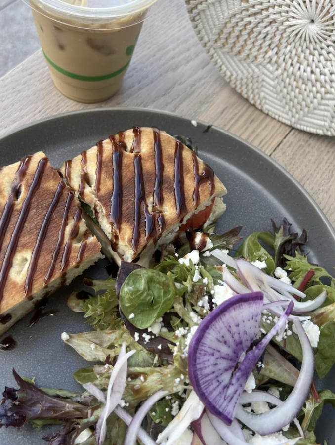 Panini with drizzled sauce, side salad