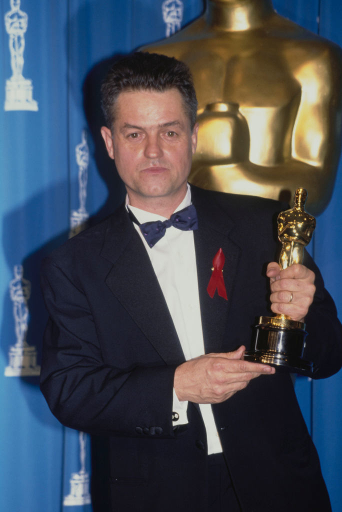 Jonathan, in a tuxedo with bow tie, holding his Oscar statuette
