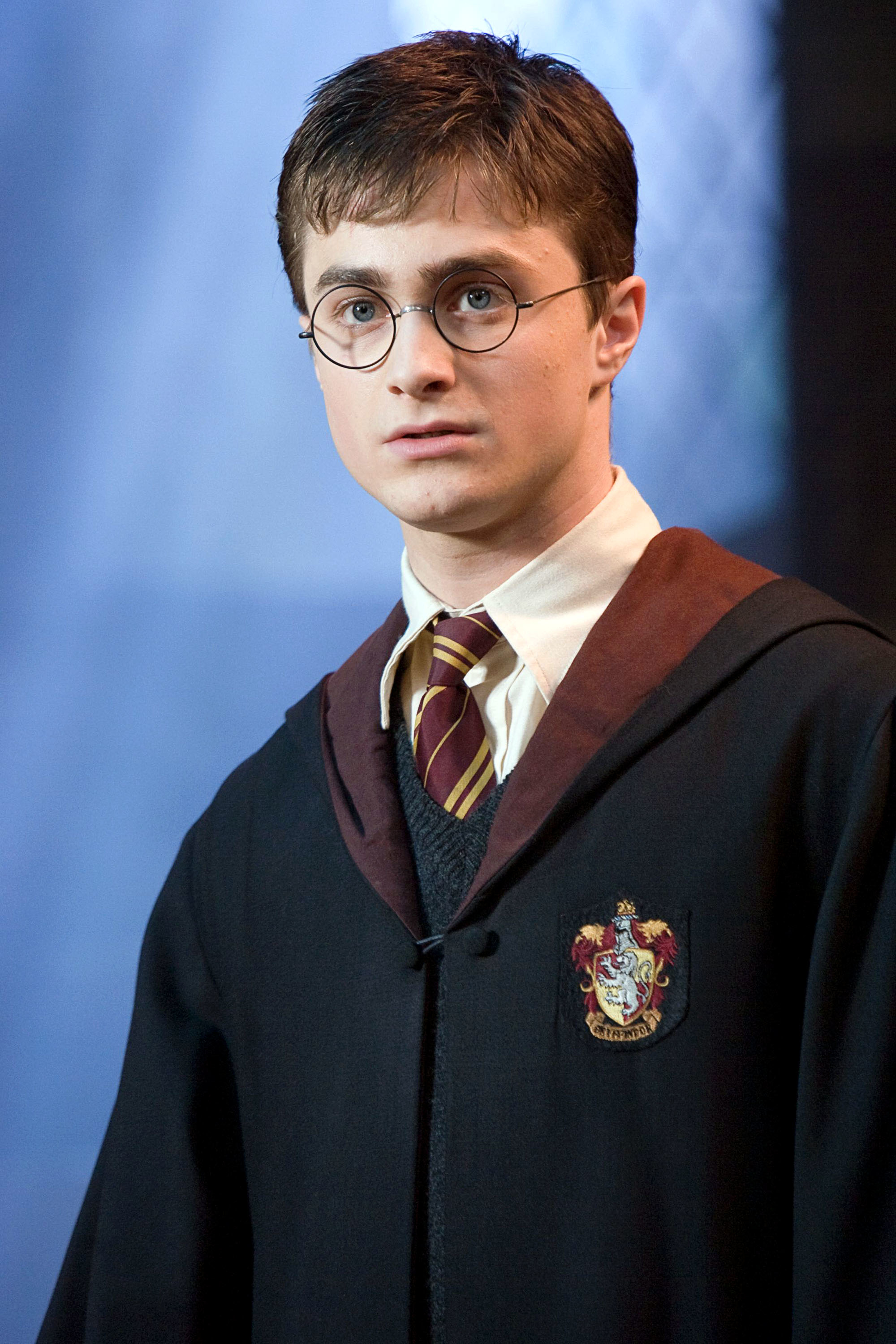Daniel Radcliffe as Harry Potter in a Hogwarts uniform with glasses and a Gryffindor tie