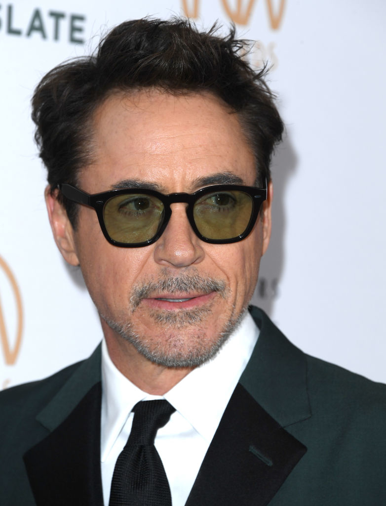 Close-up of celebrity in dark glasses and formal attire