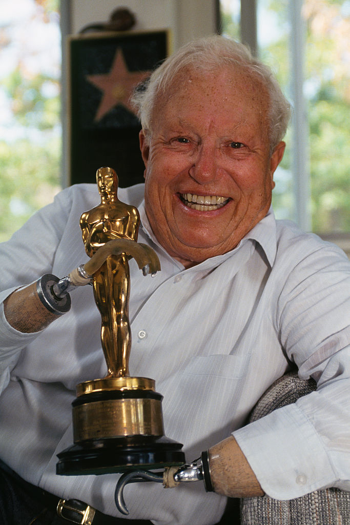 Harold, with a joyful expression holding his Oscar statuette