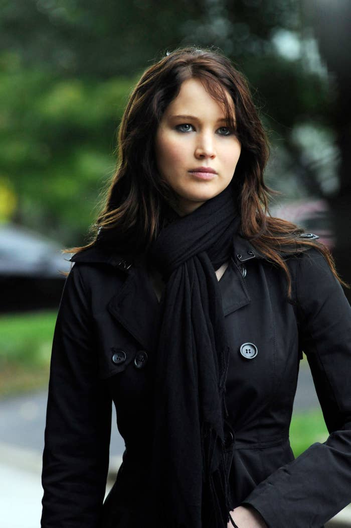 Jennifer in a black coat and scarf looking away from the camera