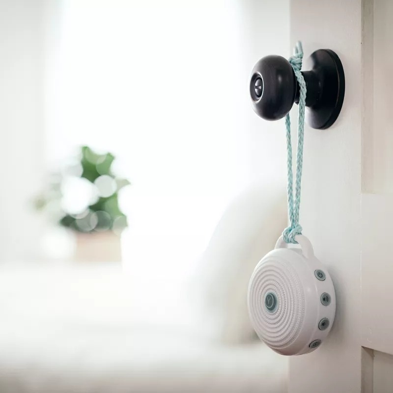 Portable doorbell attached to a door, with a sleek, modern design
