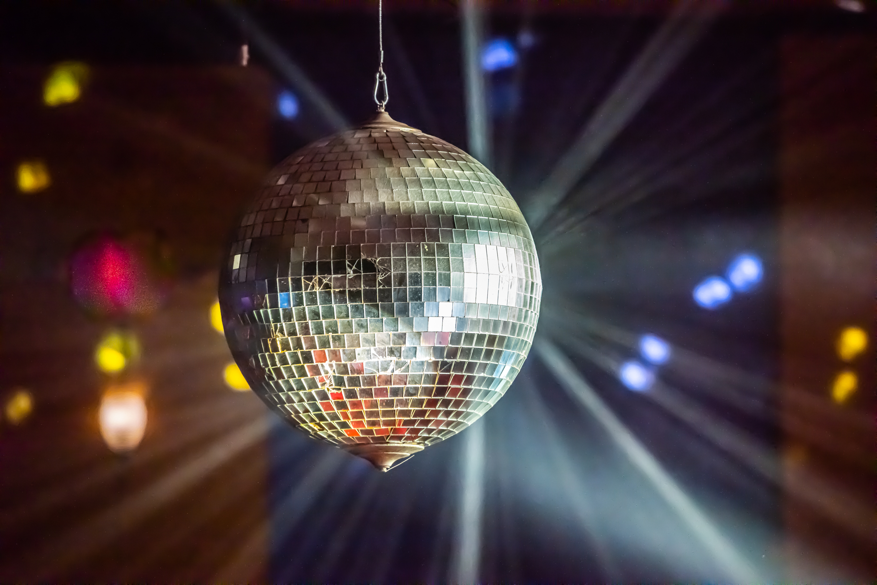 Disco ball with light rays emanating, creating a party atmosphere