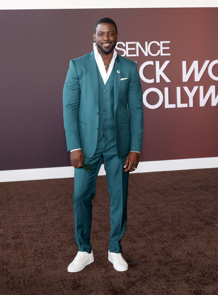 Lance in a suit and sneakers