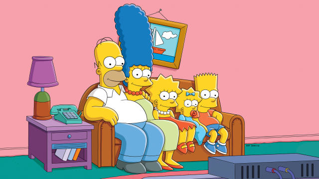 Homer, Marge, Bart, Lisa, and Maggie Simpson sitting on a couch watching TV