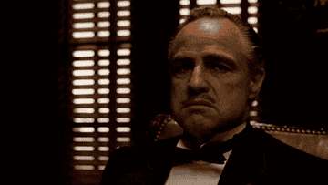Marlon Brando as Vito Corleone in &#x27;The Godfather&#x27; wearing a tuxedo, looking thoughtful
