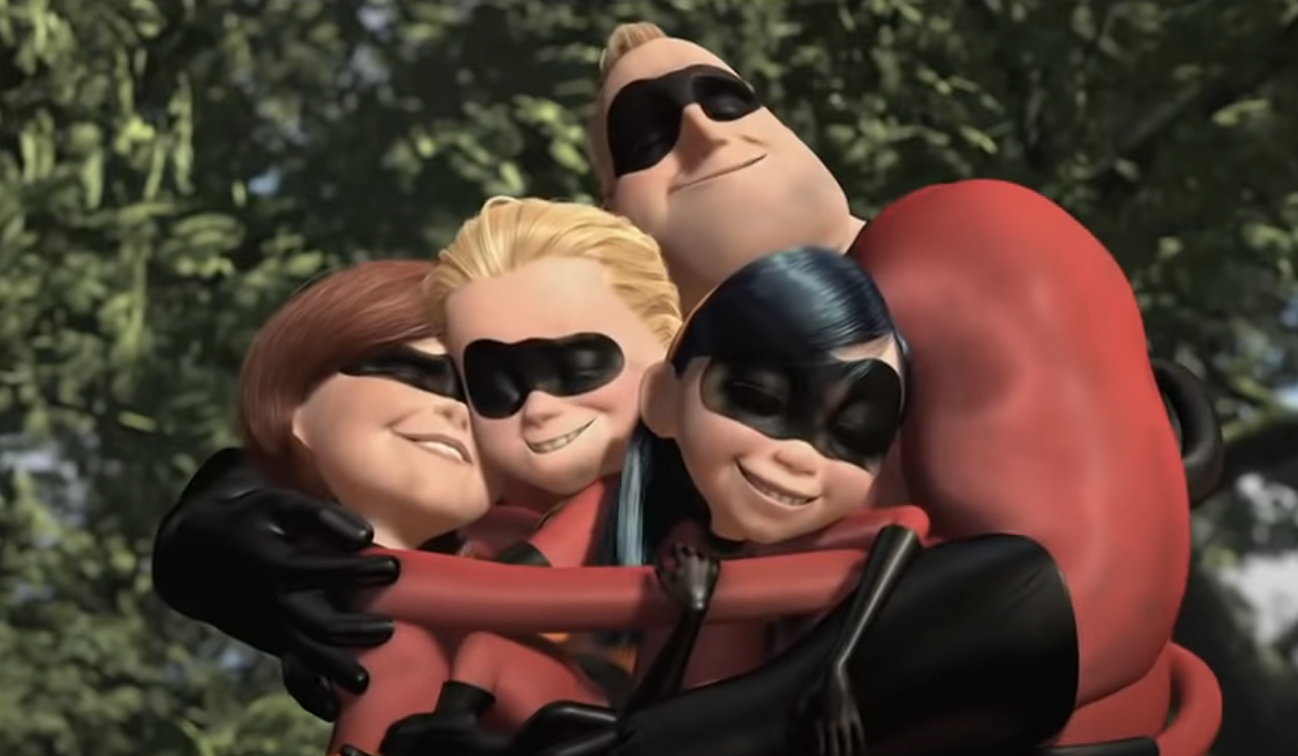 The Incredibles family in a group hug, smiling in their superhero suits