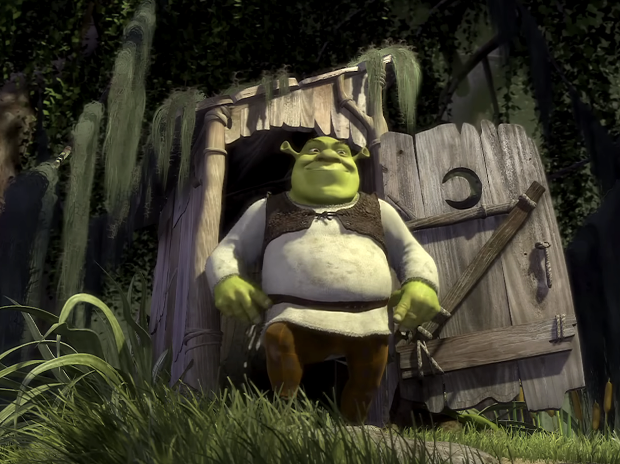 Shrek standing in front of his house with a bemused expression, holding a spear