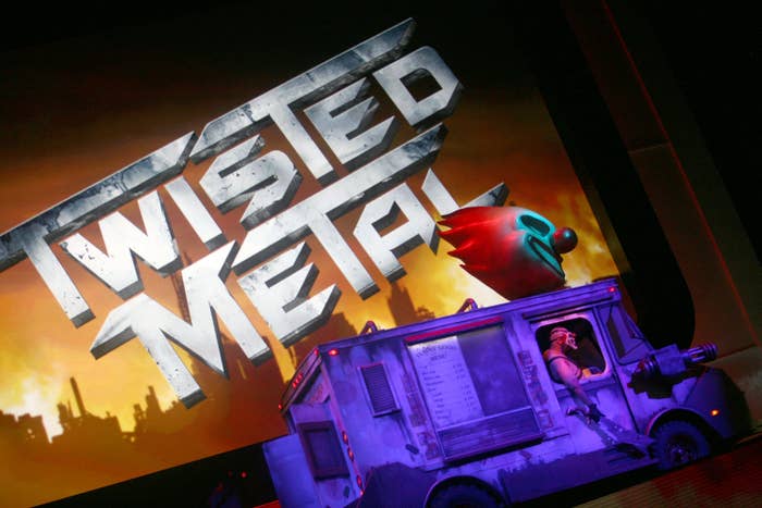 Logo of &quot;Twisted Metal&quot; video game above a model of a clown-themed ice cream truck onstage