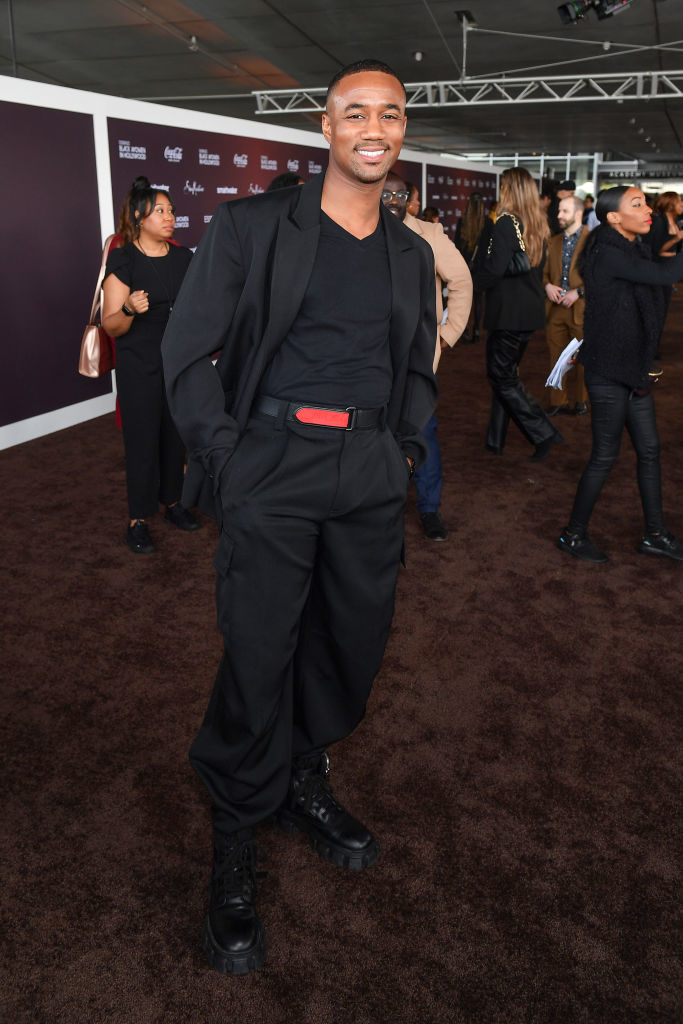 Jessie smiling in a stylish pantsuit with chunky platform boots