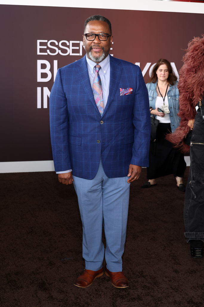 Wendell poses in a checkered suit with a patterned tie and pocket square