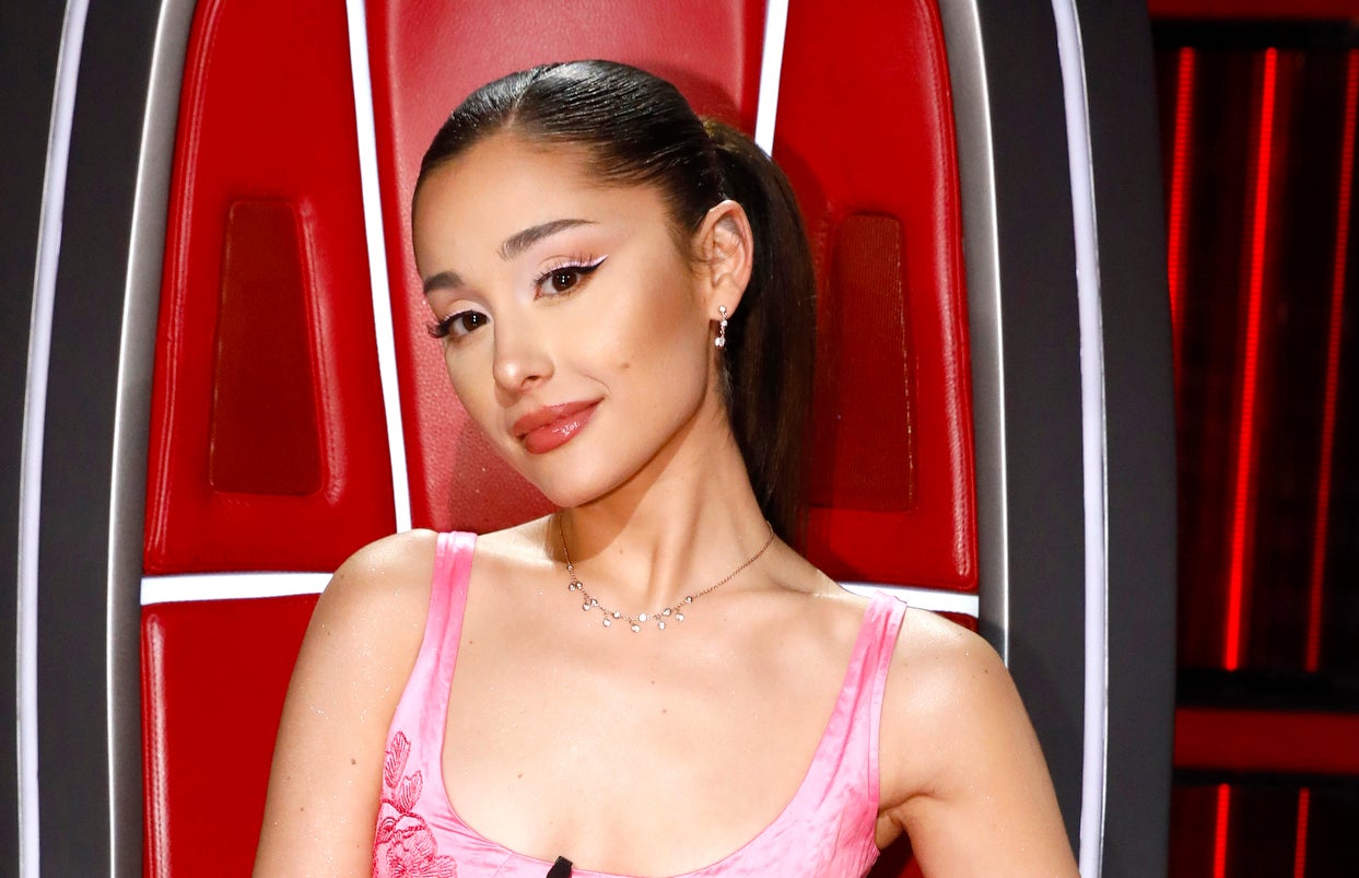 Ariana Grande seated in The Voice's red chair