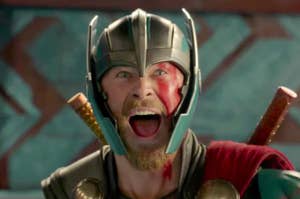 Thor in armor expressing excitement, with mouth open and eyes wide.