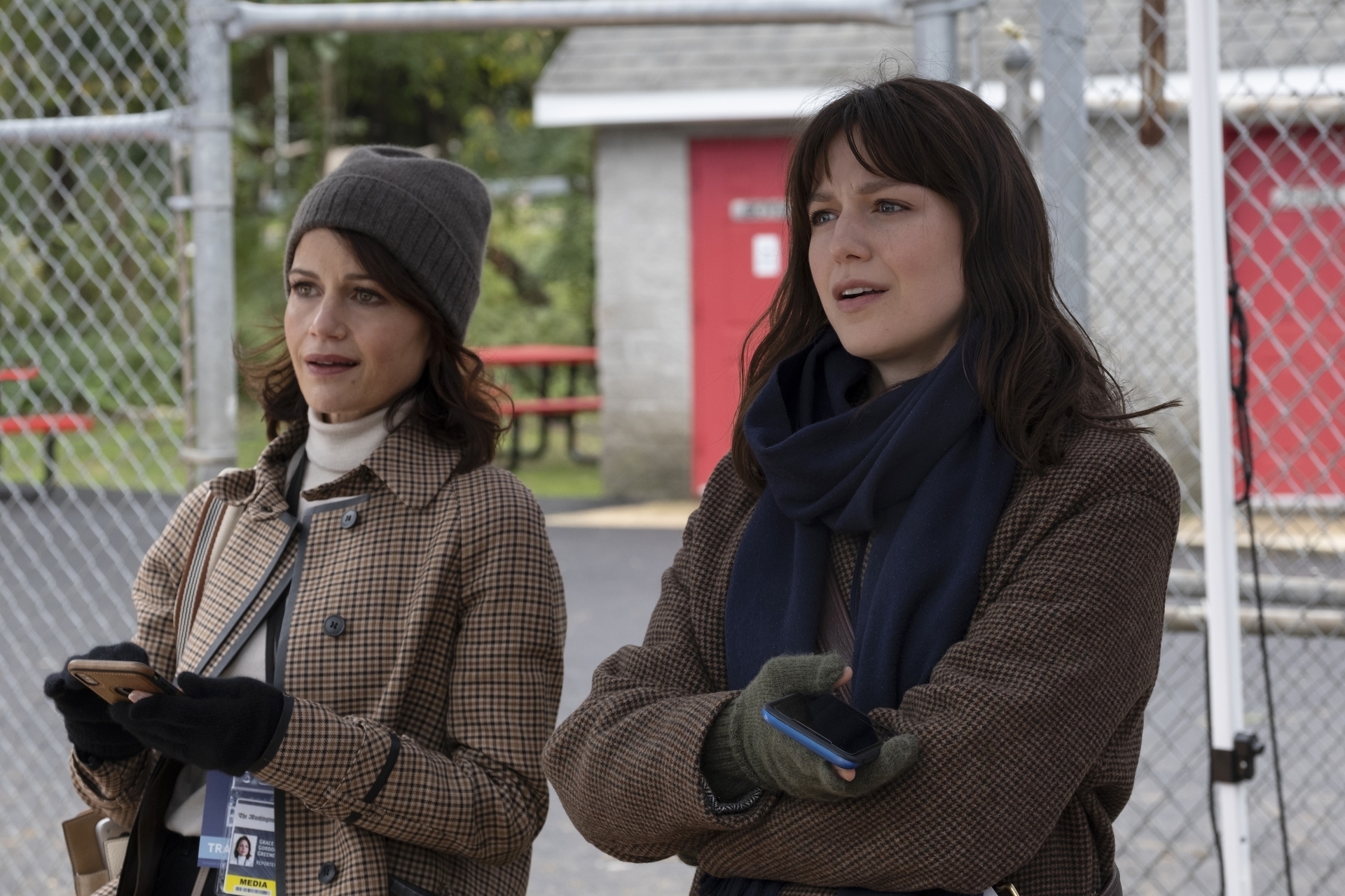 Carla Gugino and Melissa Benoist in The Girls on the Bus waiting outside in jackets