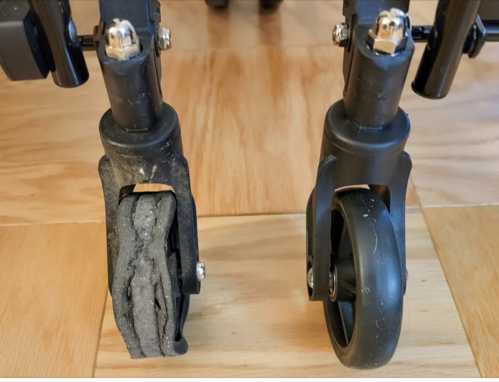 Close-up of a stroller&#x27;s worn-out left wheel beside an intact right wheel, highlighting the need for maintenance