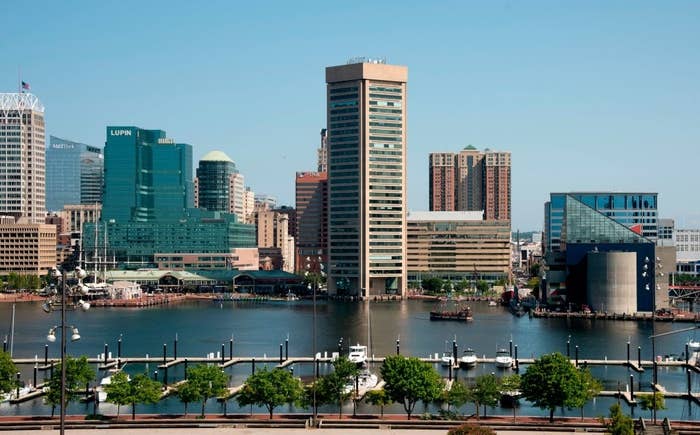 Skyline view of a city&#x27;s waterfront with modern buildings and a clear sky, depicting a travel destination