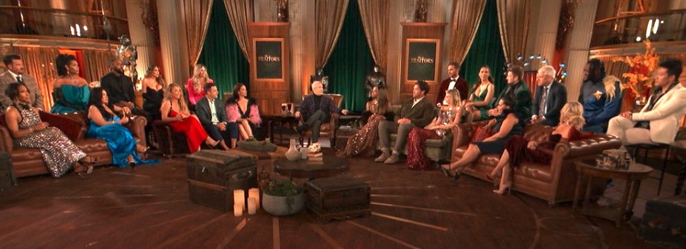 Cast of a TV show sitting in a living room set for a reunion special