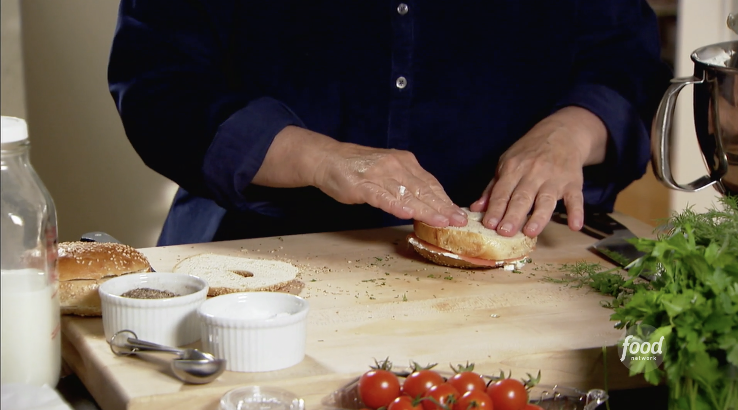 Ina prepares her bagel with lox and cream cheese