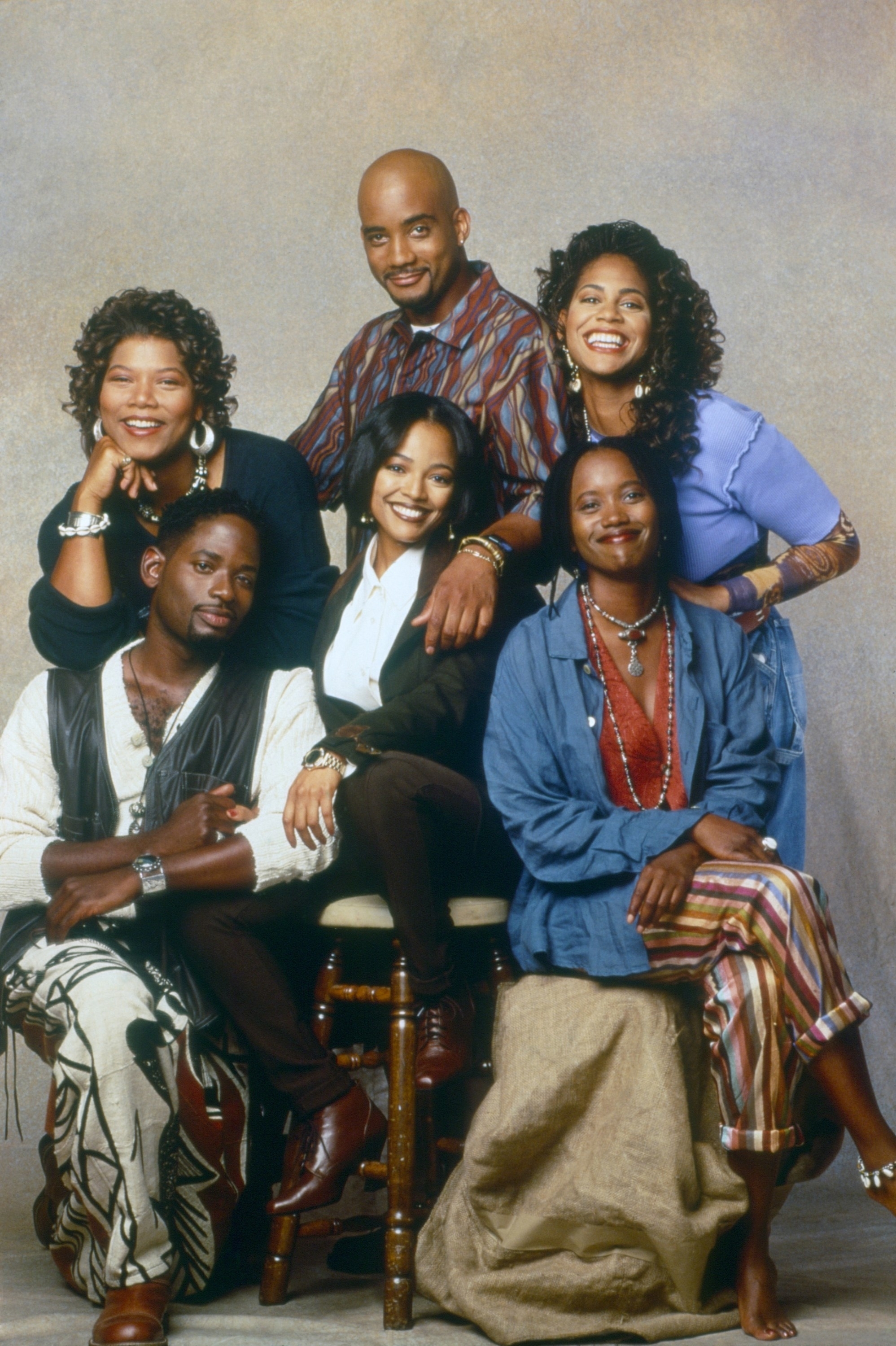 Cast of &quot;Living Single&quot; posing together and dressed in casual 90s fashion