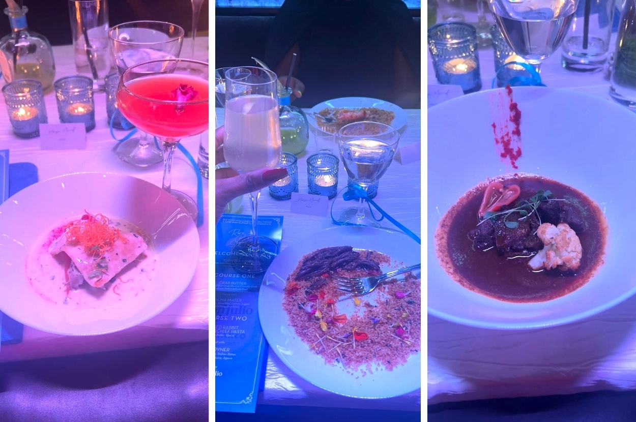 Three dishes on a table illuminated by blue light, with a person&#x27;s hand holding a cocktail