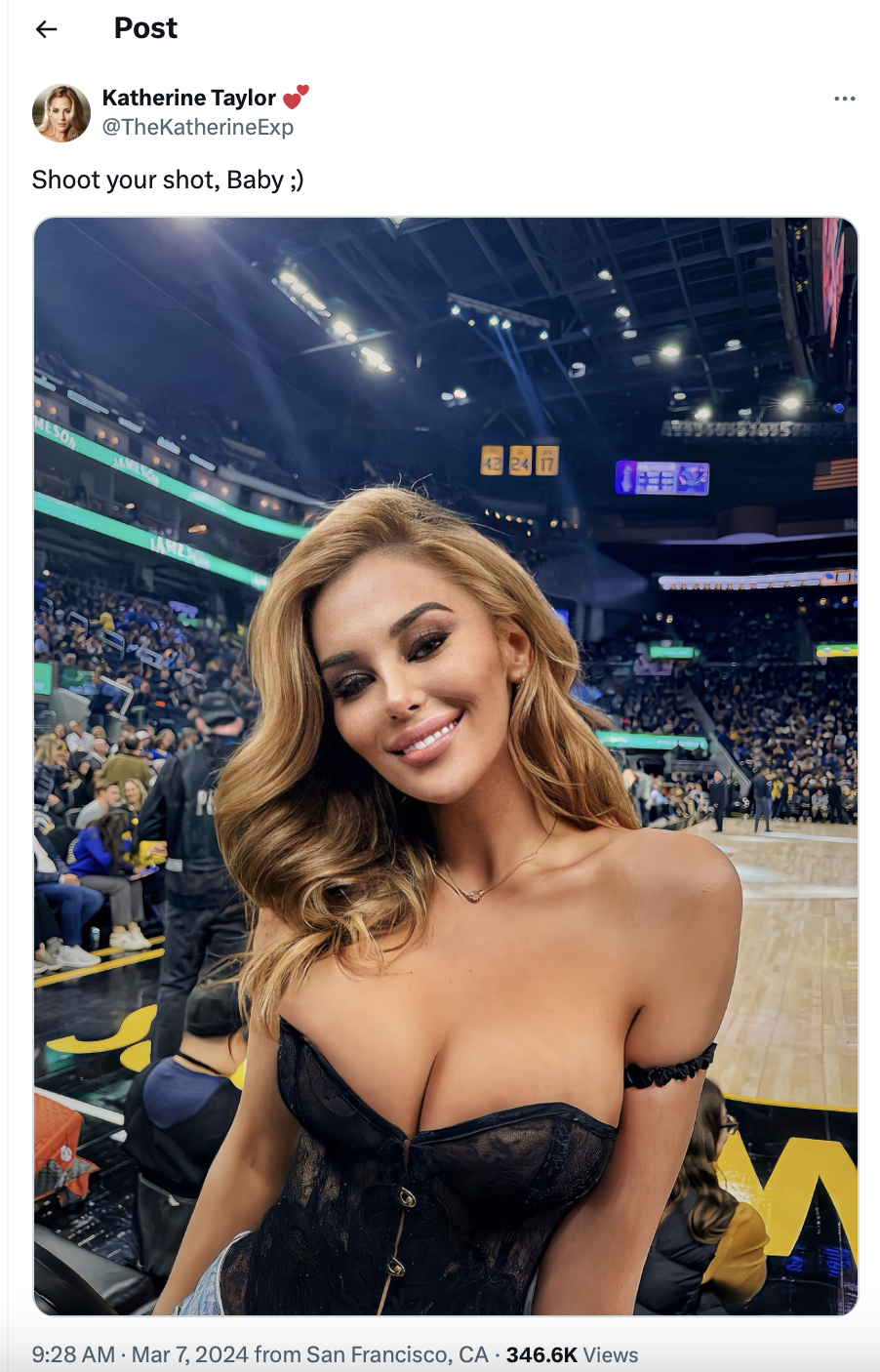 Woman in black top at basketball game with arena and crowd in background