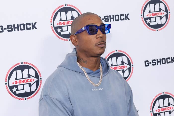 Music artist posing in a hoodie and sunglasses at a G-Shock event