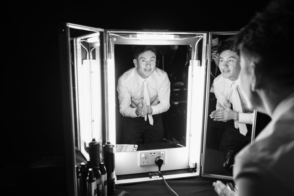 barry looking at himself in three-fold mirror
