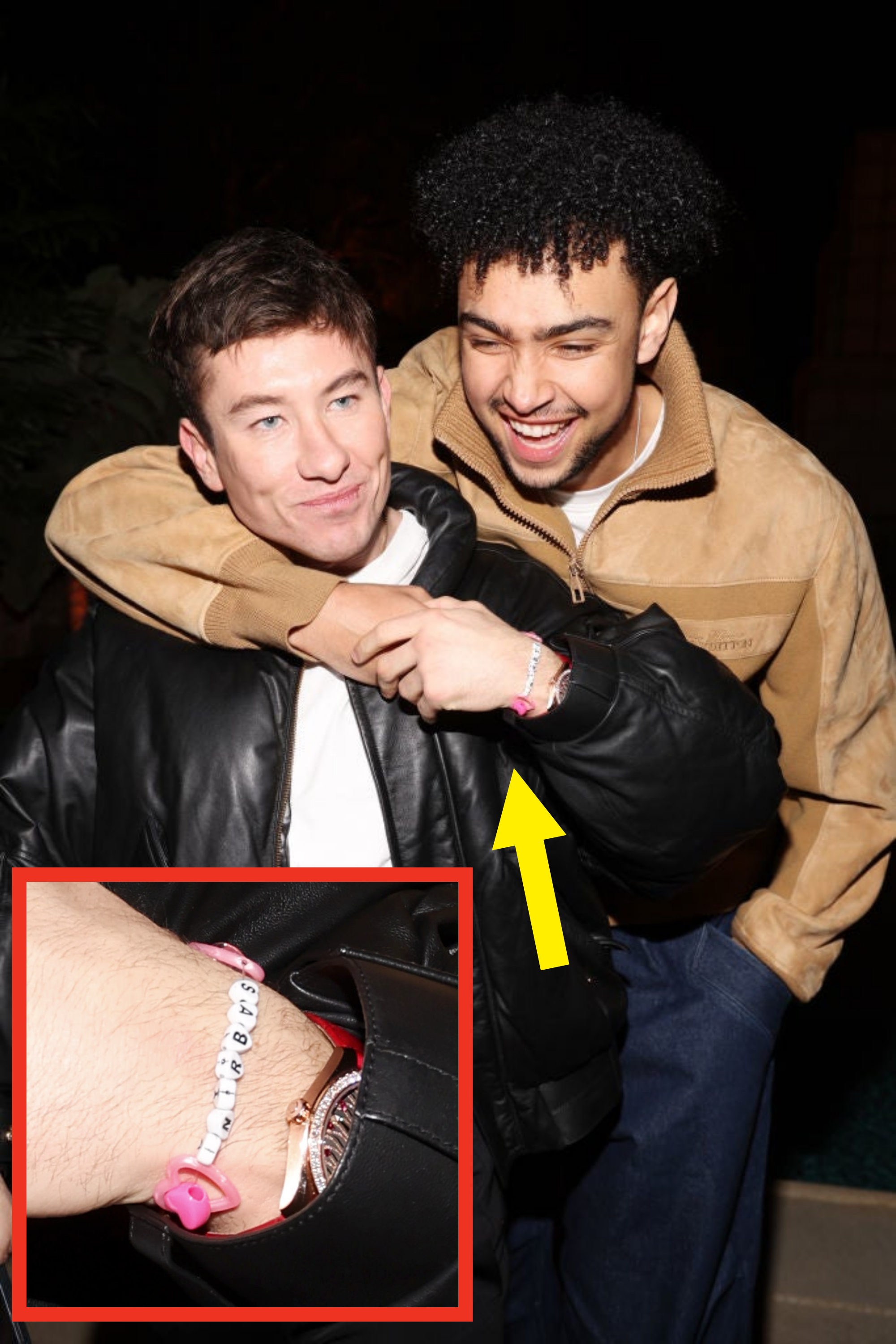 The two men smiling and embracing, the bracelet shown on barry&#x27;s wrist