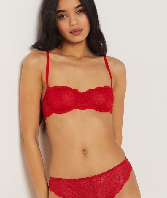 Model wearing a red lace balconette bra
