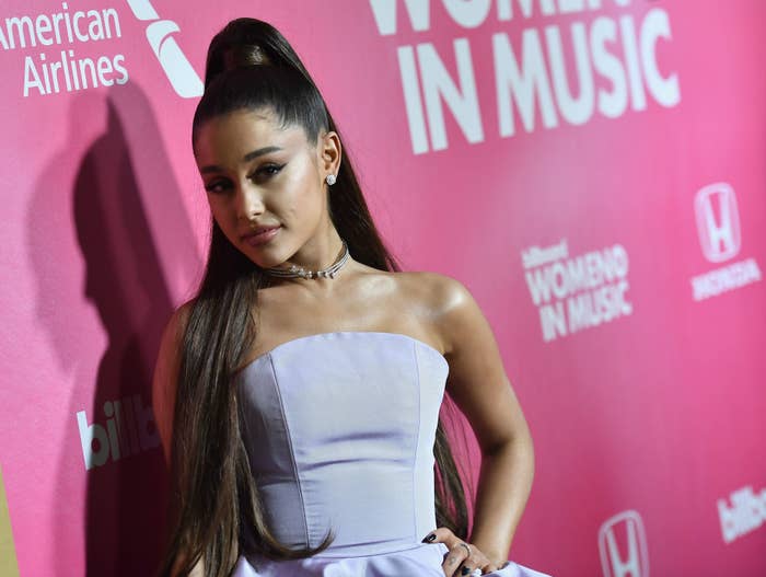 Ariana Grande poses at an event in a strapless gown with a choker necklace