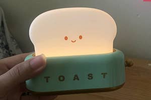A nightlight shaped like toast coming out of a toaster 