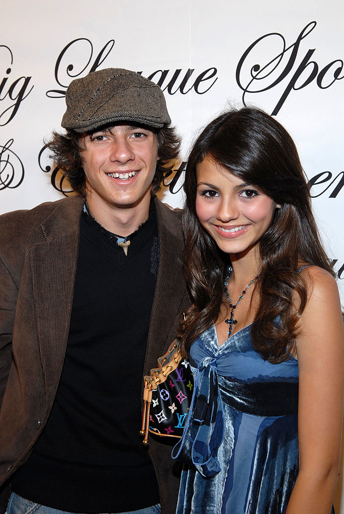 Matthew and Victoria Justice posing together at an event, both are smiling at the camera