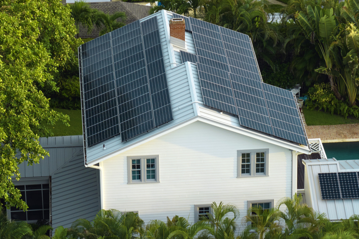 House with solar panels on roof, illustrating sustainable energy for a Nifty lifestyle article