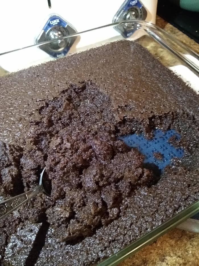 Close-up of a spoon in a tray of freshly baked brownies