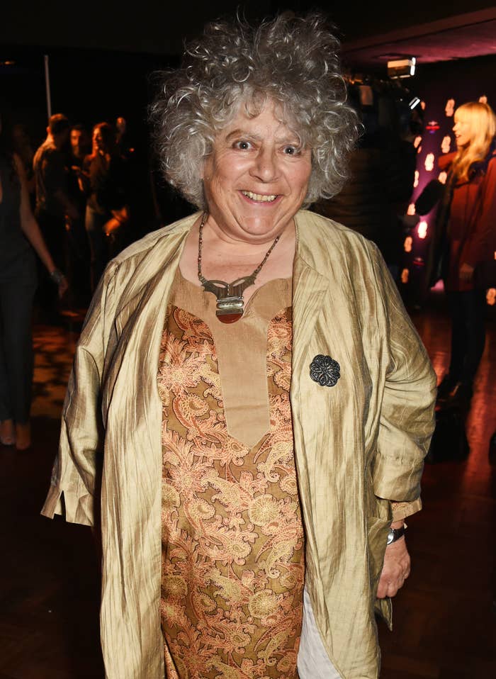Miriam at event wearing a layered outfit with a patterned dress and necklace