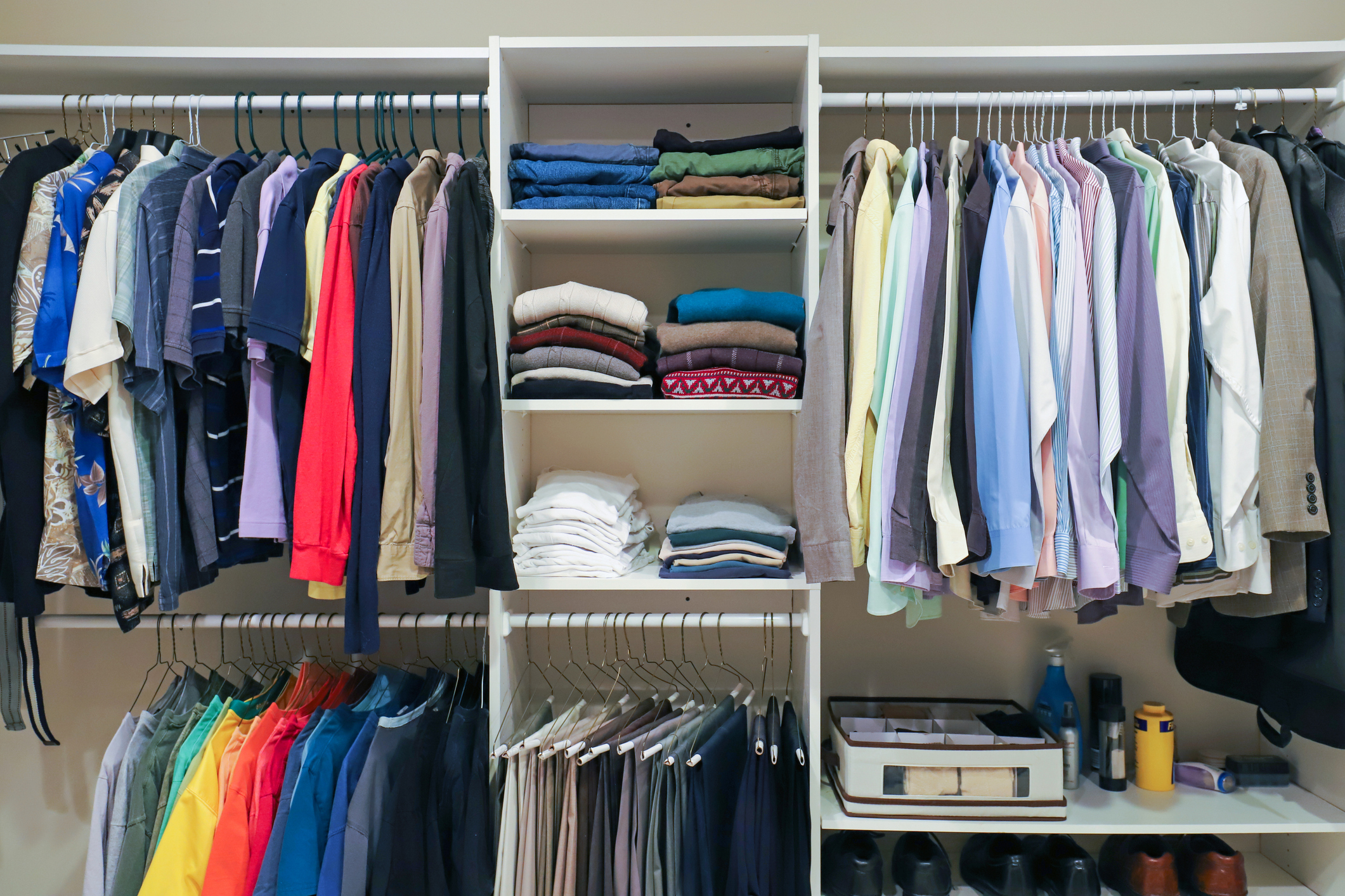 Organized closet with neatly arranged clothes and shelves with folded items