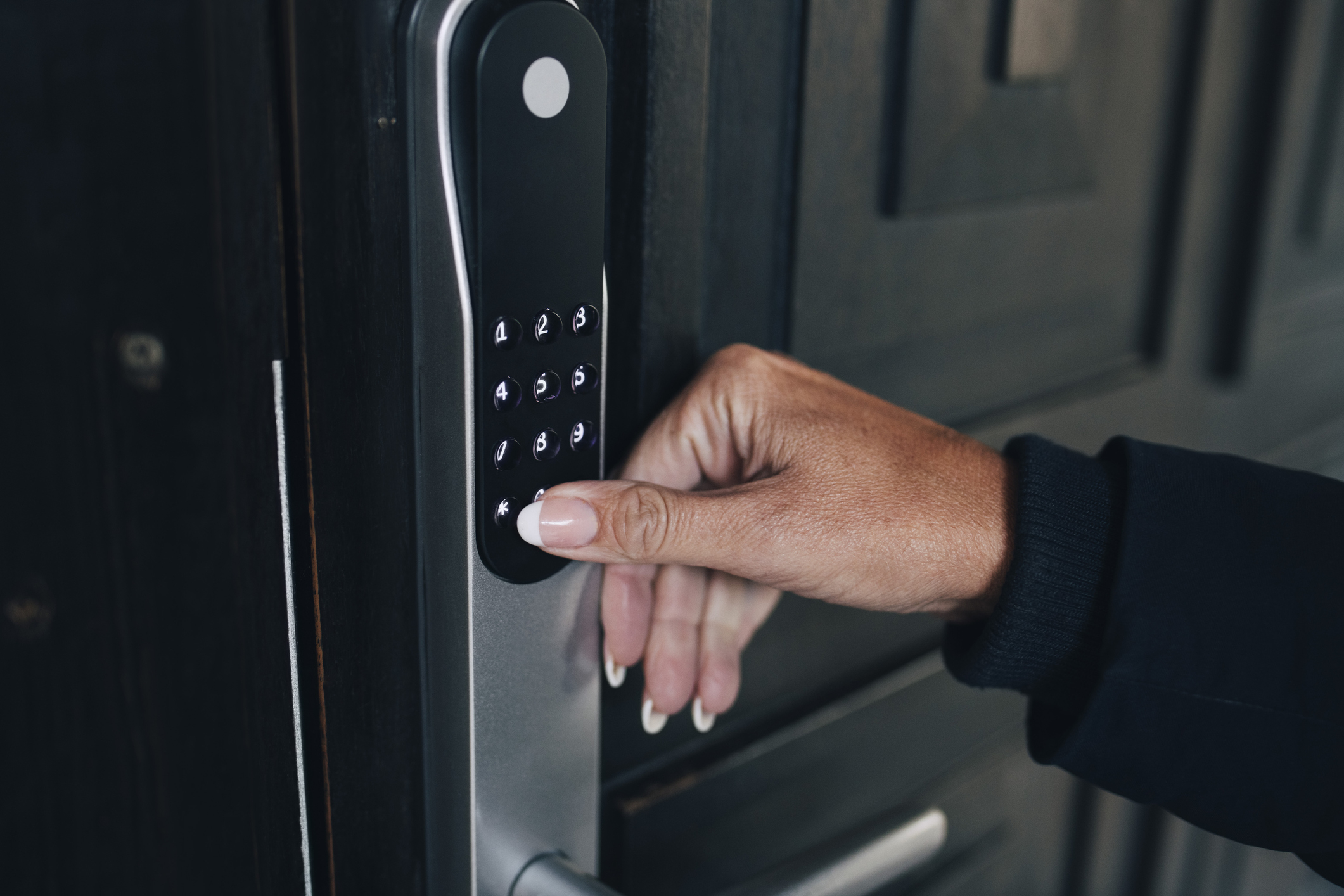 Person using a digital keypad for secure door access