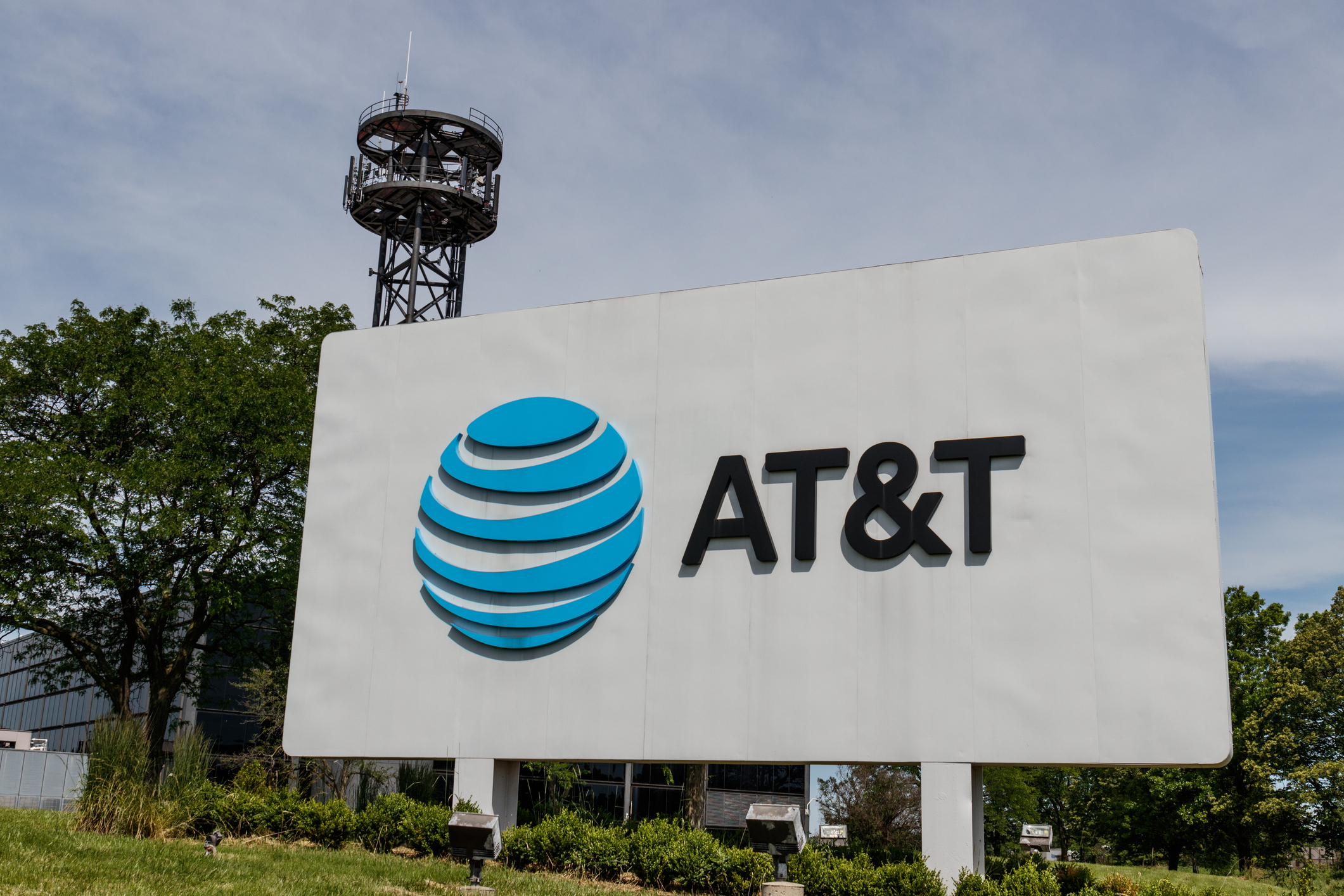 AT&amp;T sign in front of a building with a tower in the background