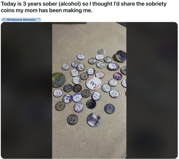 A collection of various sobriety coins spread out to celebrate a 3-year sobriety milestone
